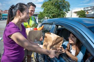 Loading groceries into a car.
